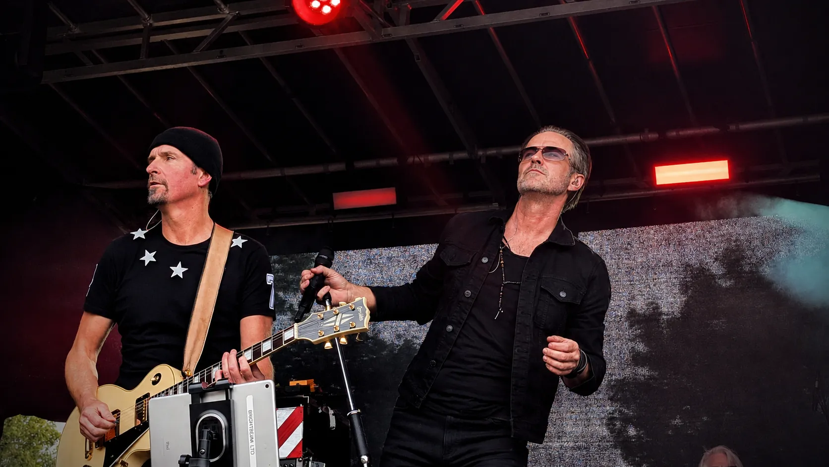 U2.V2 guitarist and frontman side by side on the main stage at the Ultimate Festival, Dumfries, under red lights