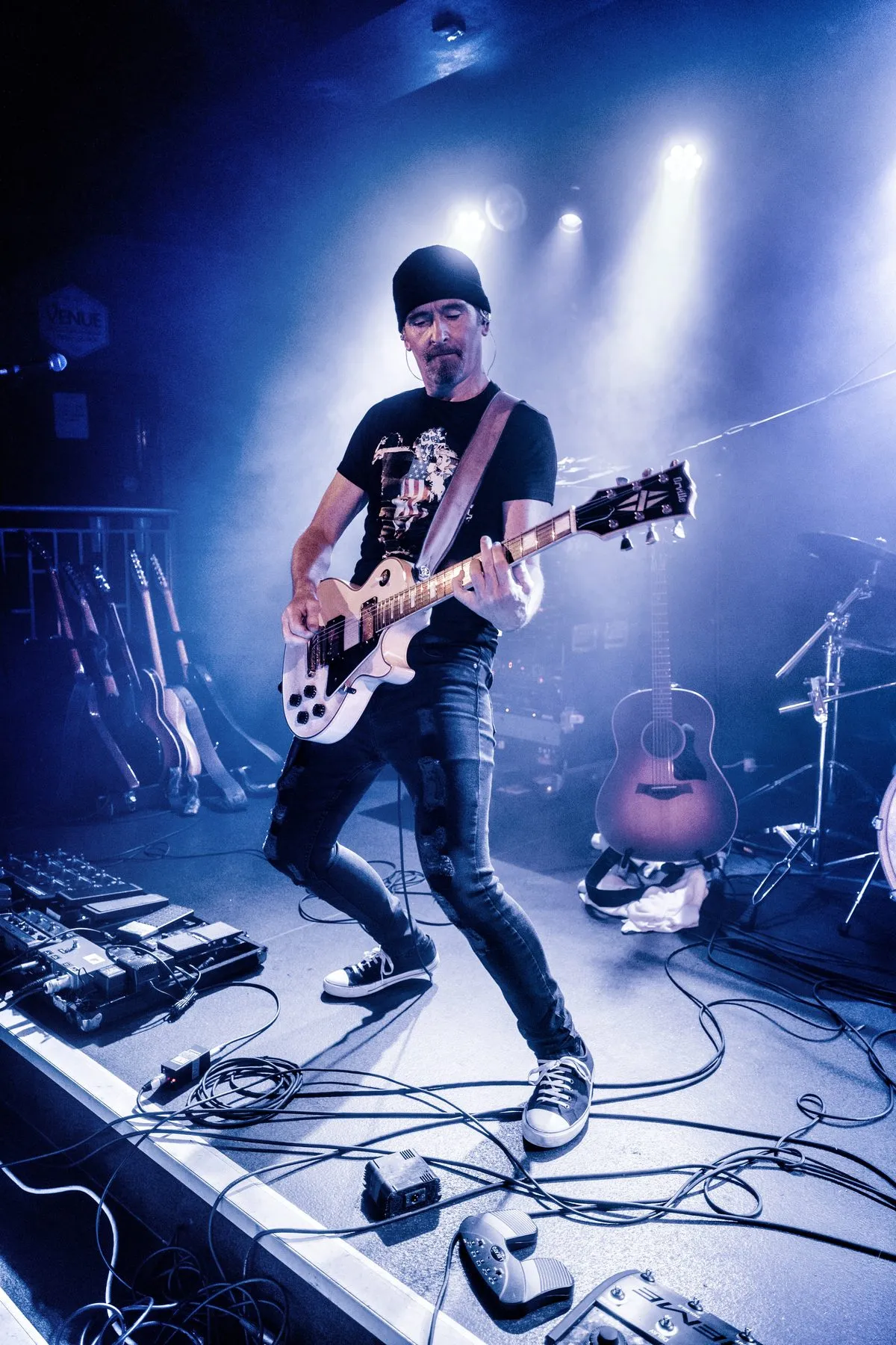 U2.V2 guitarist playing a Les Paul style guitar